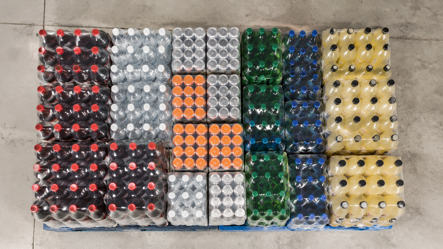 Overhead view of beverage cases arranged in a pallet loading pattern diagram on a warehouse floor, bright even lighting, commercial photography, landscape composition
