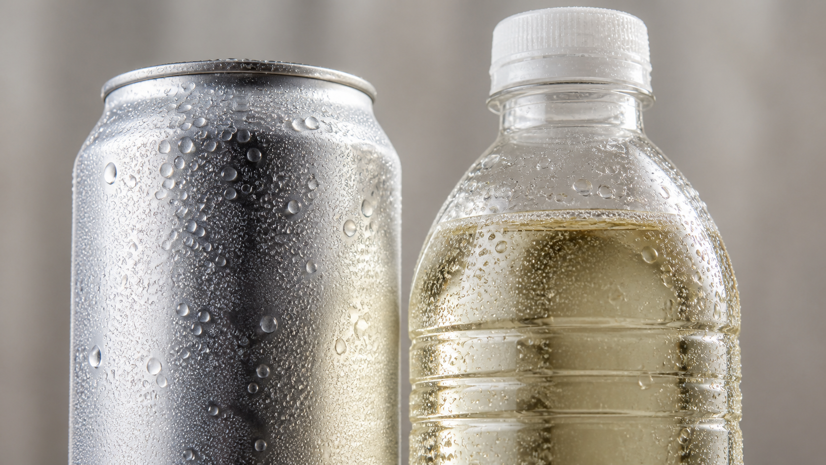 Close-up of an aluminium can and PET bottle with condensation