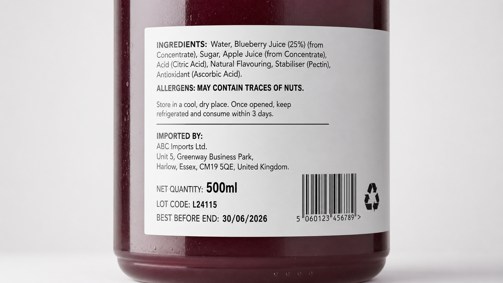 Close-up of beverage label showing UK importer address and allergens