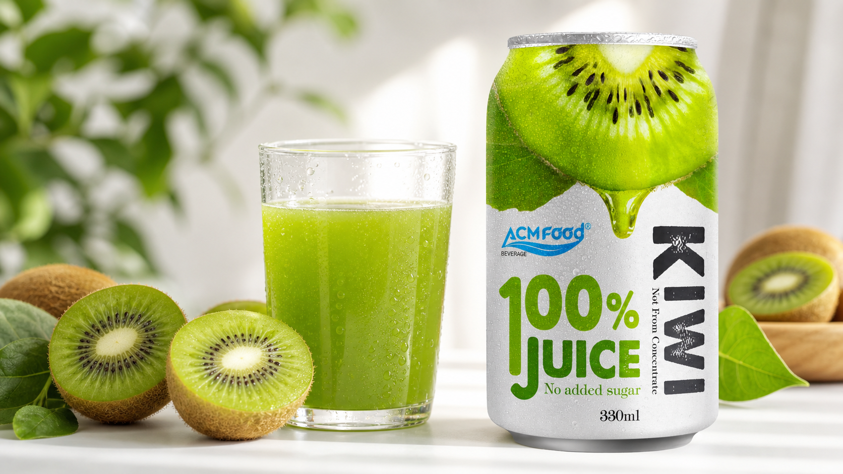Fresh green kiwifruit halves next to a clear glass of kiwi juice