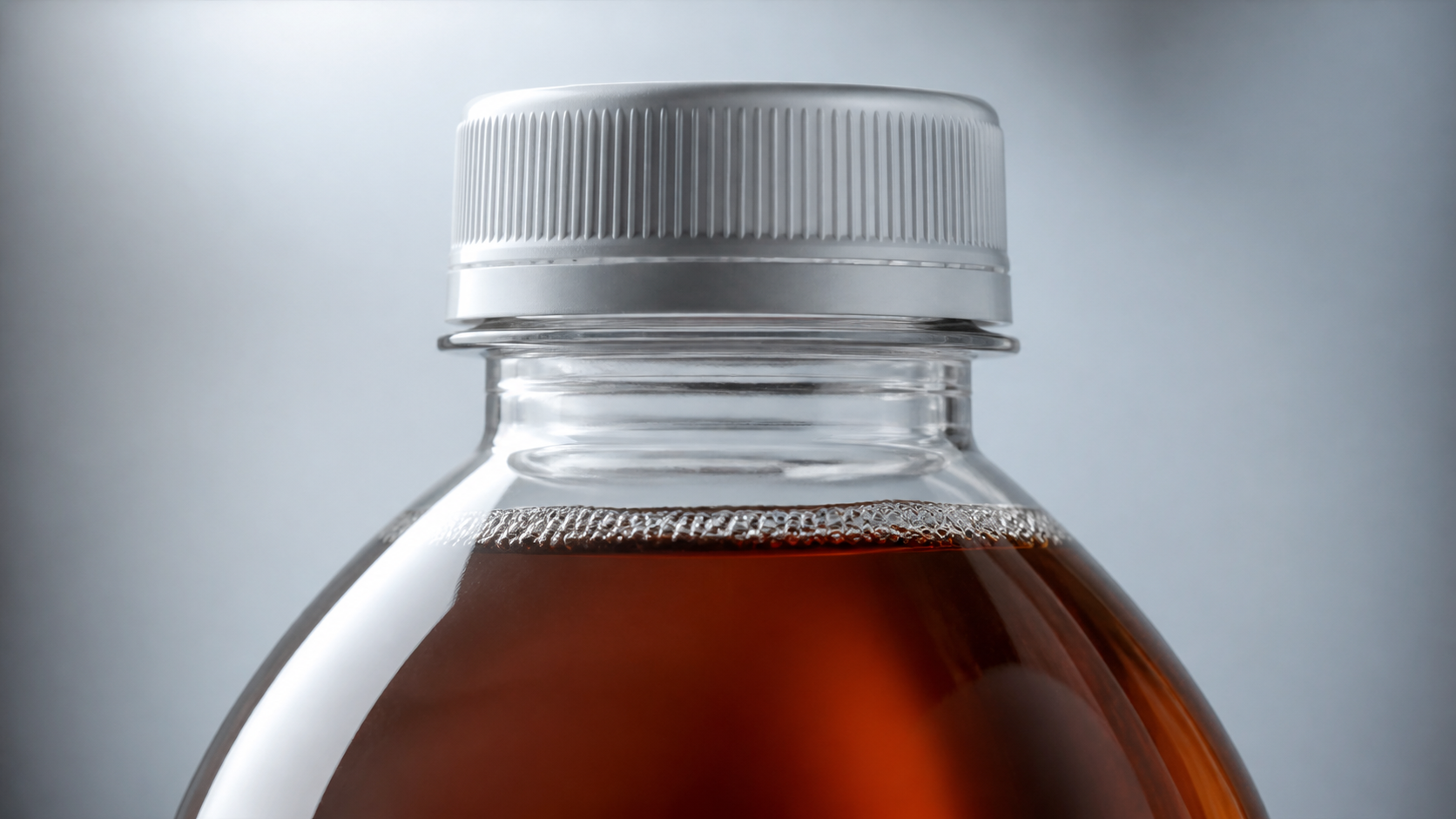 Close up of sealed PET bottle with minimal headspace and nitrogen bubbles