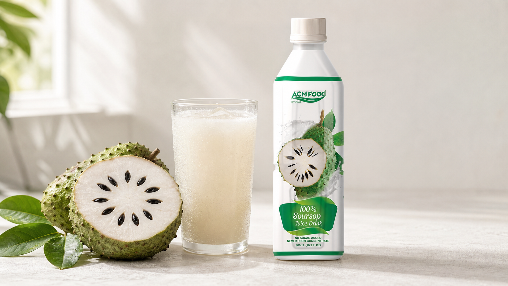 Fresh soursop fruit with leaves beside a glass of chilled soursop juice
